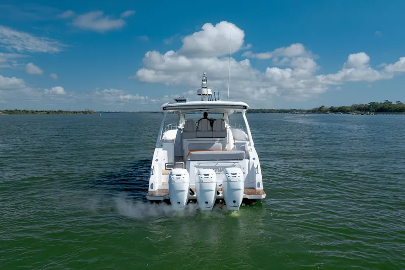 Slide: The Image of 2019 Azimut Verve 40 yacht cruising on a serene lake under a clear blue sky. - 16