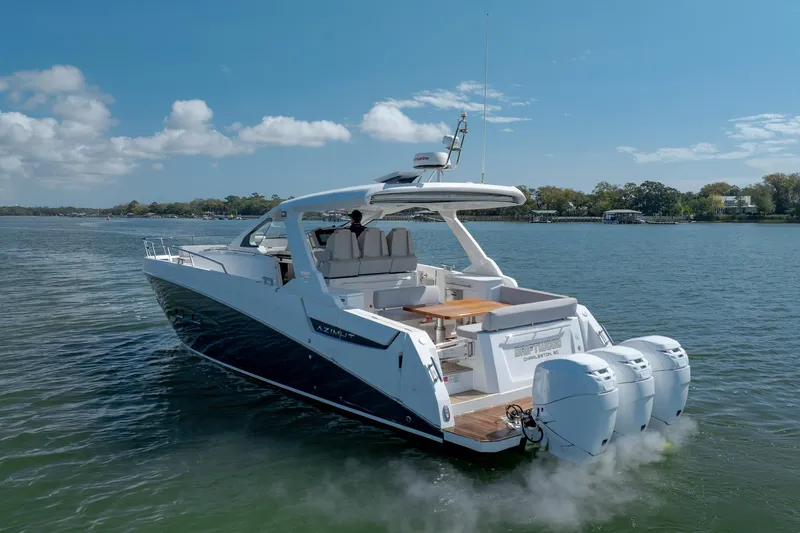 Slide: The Image of 2019 Azimut Verve 40 yacht cruising on a calm lake under a clear blue sky. - 18