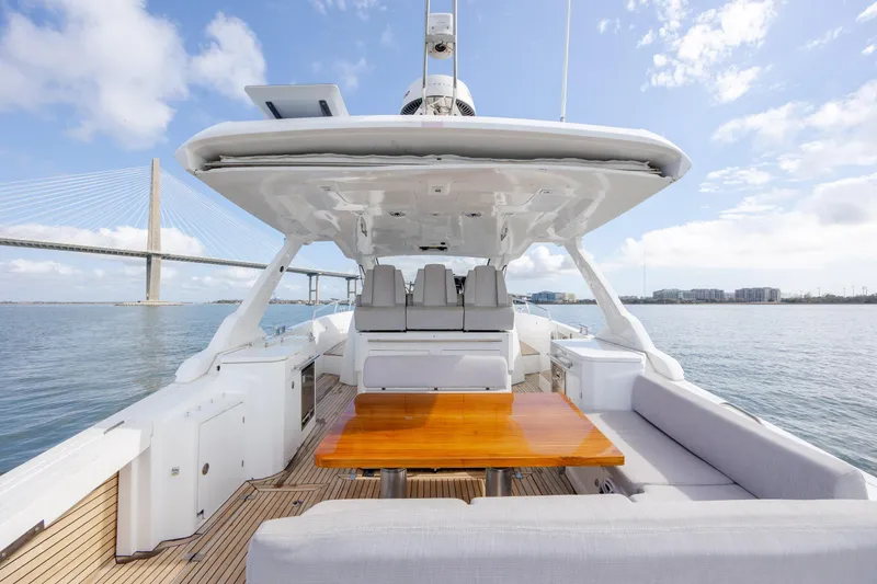 Slide: The Image of 2019 Azimut Verve 40 yacht with spacious deck, wooden table, and scenic bridge view. - 30