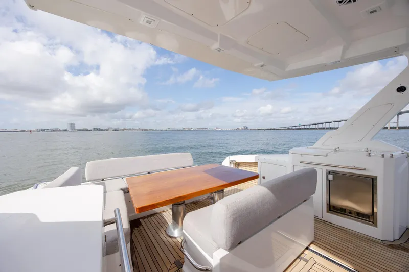 Slide: The Image of 2019 Azimut Verve 40 yacht deck with seating, table, and ocean view. - 34