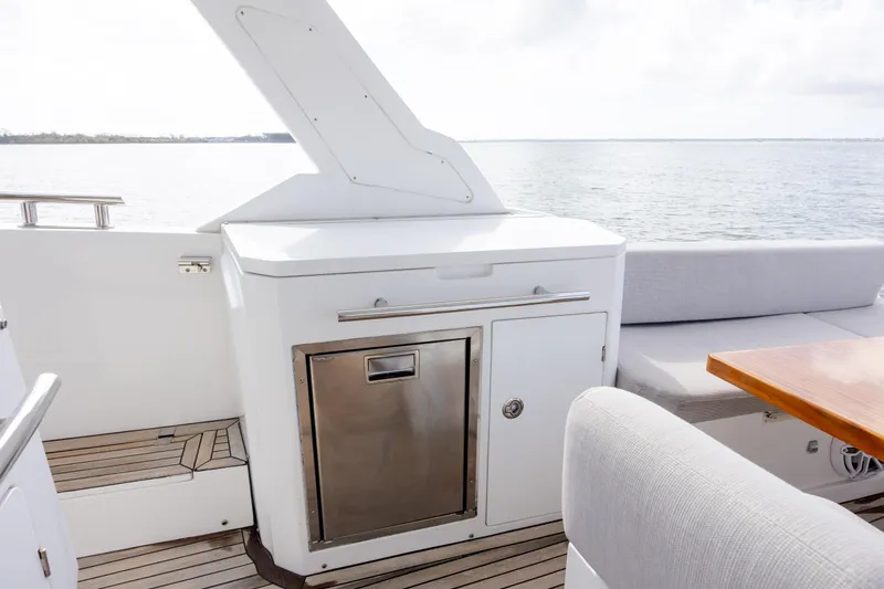 Slide: The Image of 2019 Azimut Verve 40 yacht deck with seating and storage, overlooking serene waters. - 38