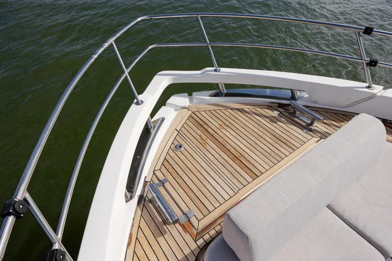 Slide: The Image of 2019 Azimut Verve 40 yacht deck with teak flooring and cushioned seating. - 56