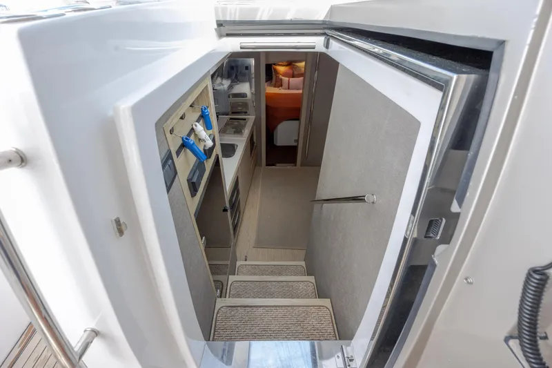 Slide: The Image of Interior view of 2019 Azimut Verve 40 yacht, featuring stairs and compact kitchen area. - 60