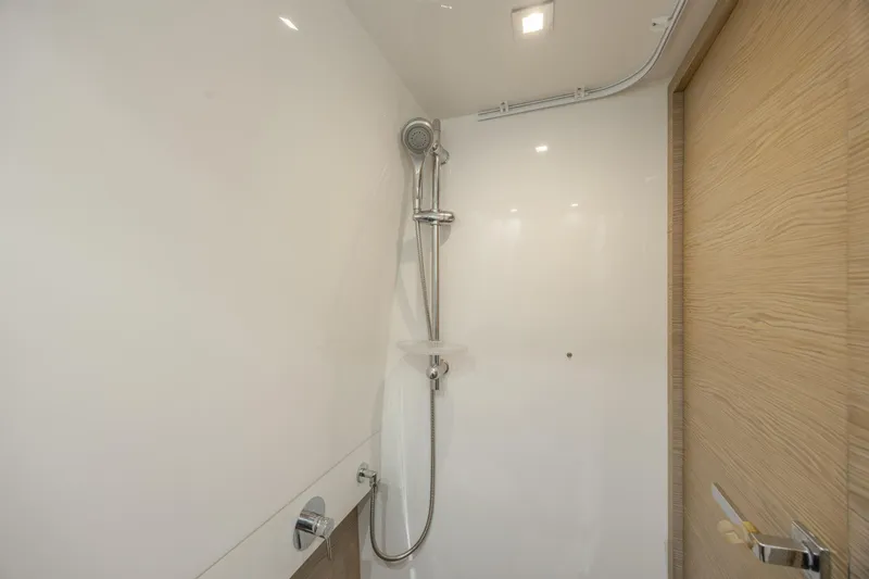 Slide: The Image of Shower area in 2019 Azimut Verve 40 yacht, featuring modern fixtures and wooden door. - 70