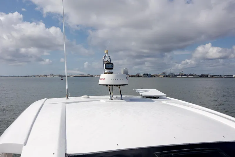 Slide: The Image of 2019 Azimut Verve 40 yacht roof with radar, overlooking calm waters and cloudy sky. - 77