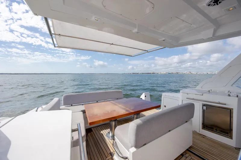 Slide: The Image of 2019 Azimut Verve 40 yacht deck with seating, table, and ocean view. - 78
