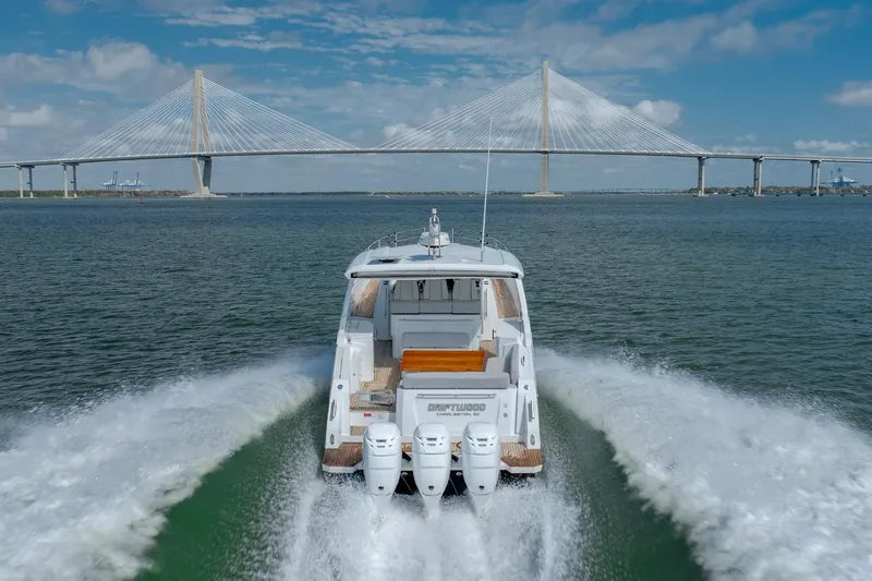 Slide: The Image of 2019 Azimut Verve 40 yacht cruising under a suspension bridge on a sunny day. - 9