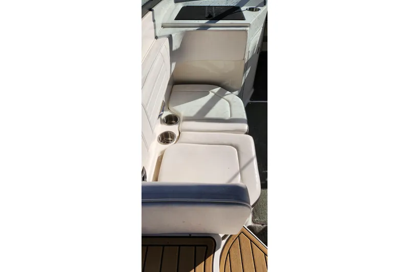 Slide: The Image of 2019 Sea Ray SPX 190 Outboard boat interior with white seating and cup holders. - 16