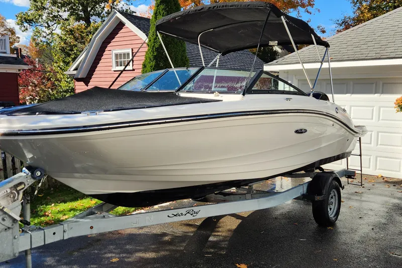 Slide: The Image of 2019 Sea Ray SPX 190 Outboard boat on trailer, parked in driveway, sunny day. - 2