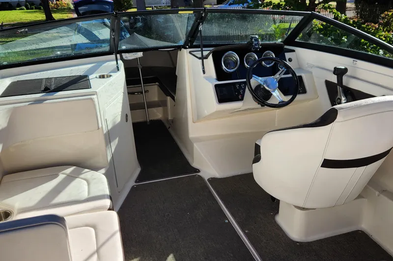 Slide: The Image of 2019 Sea Ray SPX 190 Outboard boat interior with steering wheel and seating. - 4