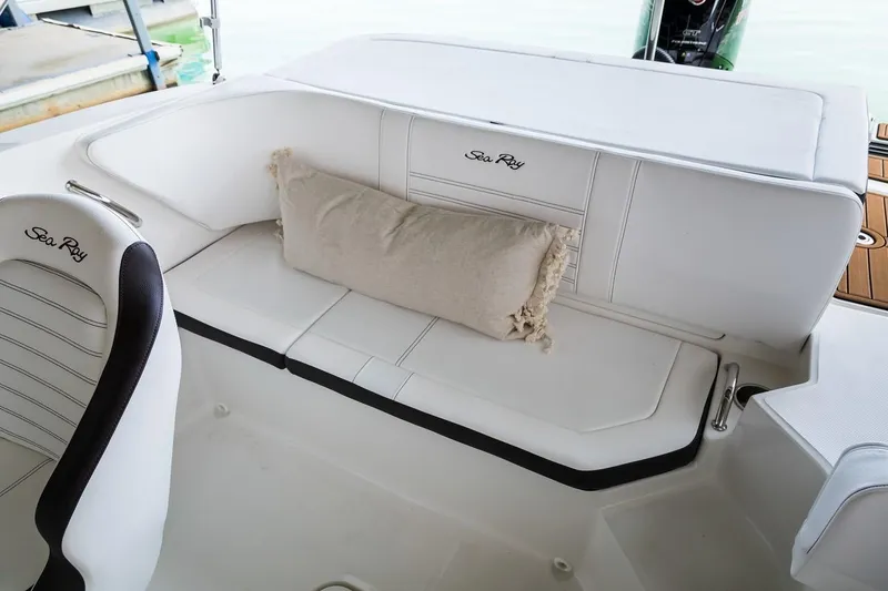 Slide: The Image of Manufacturer Provided Image: 2019 Sea Ray SPX 190 OB boat interior with white seating and cushion. - 7