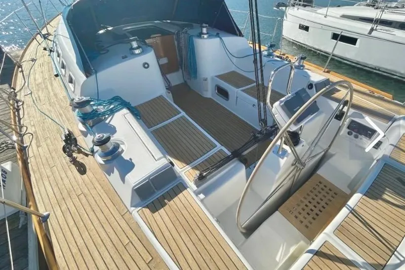 Slide: The Image of 2003 Beneteau First 47.7 sailboat cockpit with wooden deck and steering wheel. - 4