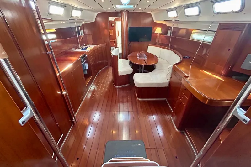 Slide: The Image of Luxurious interior of 2003 Beneteau First 47.7 yacht with polished wood and cozy seating. - 5