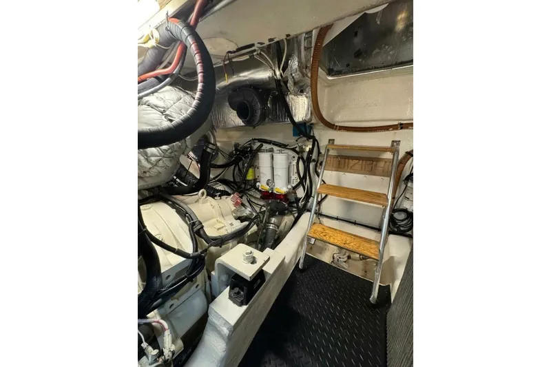 Slide: The Image of Engine room of 2002 Riviera 43 Open Flybridge with ladder and mechanical components. - 13