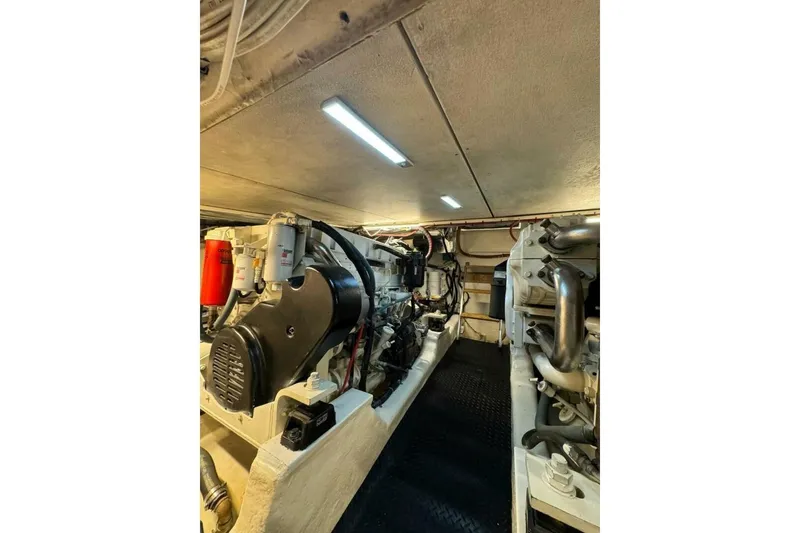 Slide: The Image of Engine room of 2002 Riviera 43 Open Flybridge yacht, showcasing mechanical components. - 14