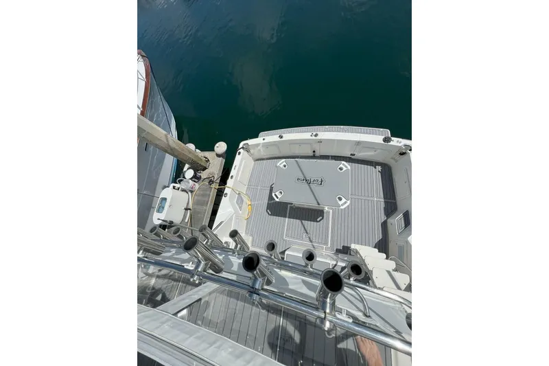 Slide: The Image of 2002 Riviera 43 Open Flybridge boat deck view at marina. - 16