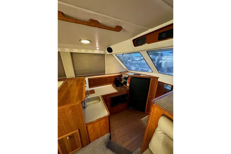 Slide: The Image of Interior of 2002 Riviera 43 Open Flybridge with wood finishes and modern amenities. - 3