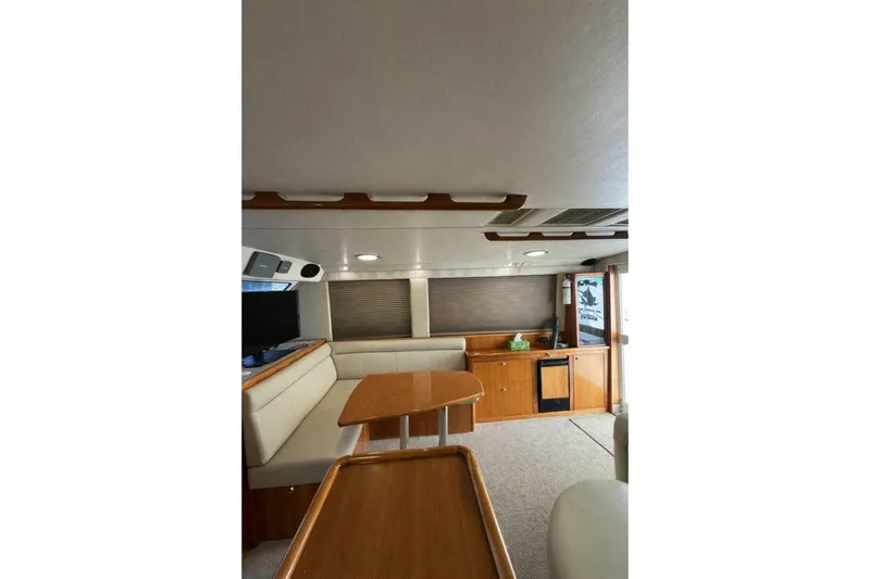 Slide: The Image of Interior of 2002 Riviera 43 Open Flybridge yacht with wood accents and seating area. - 5