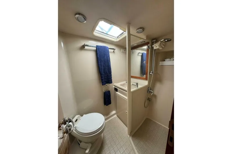 Slide: The Image of Bathroom interior of 2002 Riviera 43 Open Flybridge yacht, featuring shower and toilet. - 7