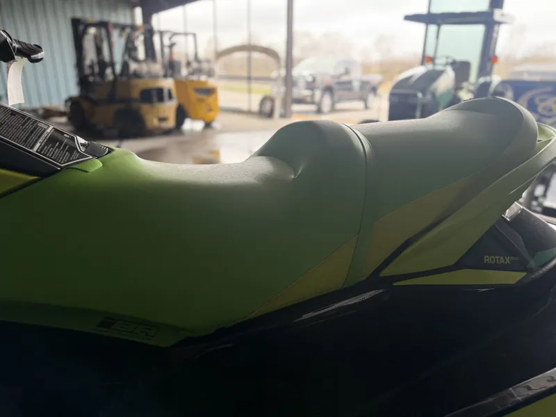 Slide: The Image of 2019 Sea-Doo jet ski with green seat in warehouse. - 6