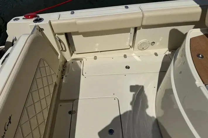 Slide: The Image of 2018 Chris-Craft Catalina 30 boat interior with beige seating and storage compartments. - 14