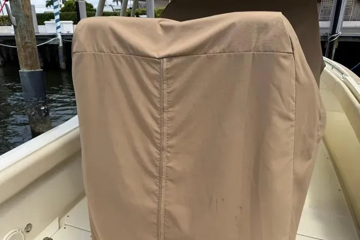 Slide: The Image of 2018 Chris-Craft Catalina 30 boat with covered seating, docked by the water. - 15