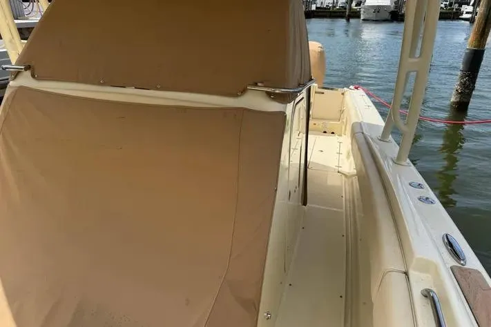 Slide: The Image of 2018 Chris-Craft Catalina 30 boat with tan cover docked by the water. - 17