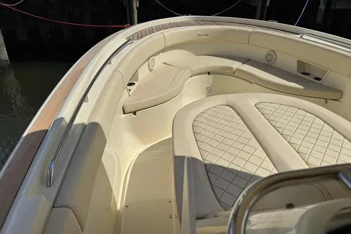 Slide: The Image of 2018 Chris-Craft Catalina 30 boat interior with beige cushioned seating and elegant design. - 18