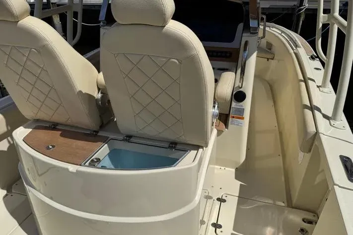 Slide: The Image of 2018 Chris-Craft Catalina 30 boat interior with beige seats and console. - 24