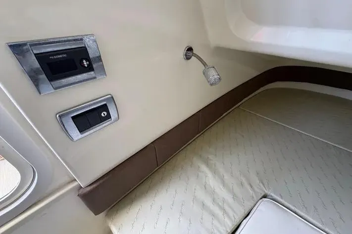 Slide: The Image of 2018 Chris-Craft Catalina 30 cabin interior with control panel and reading light. - 26