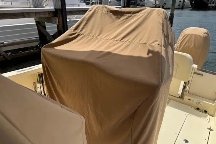 Slide: The Image of 2018 Chris-Craft Catalina 30 boat with protective cover at dockside. - 28