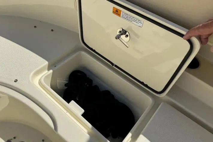 Slide: The Image of Storage compartment on a 2018 Chris-Craft Catalina 30 boat, open with contents inside. - 29