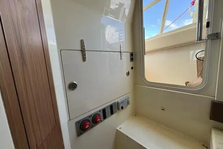 Slide: The Image of 2018 Chris-Craft Catalina 30 interior with control panel and seating area. - 33