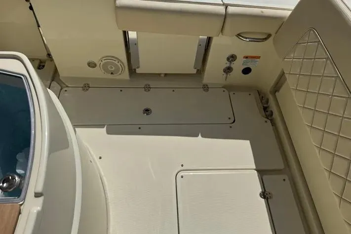 Slide: The Image of 2018 Chris-Craft Catalina 30 boat interior with cushioned seating and storage compartments. - 34