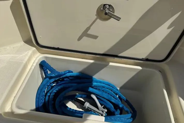 Slide: The Image of Storage compartment with blue rope on a 2018 Chris-Craft Catalina 30 boat. - 35