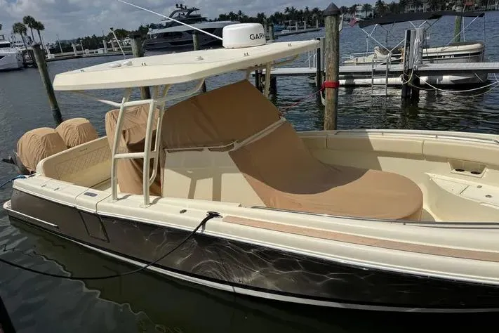Slide: The Image of 2018 Chris-Craft Catalina 30 boat docked, featuring a sleek design and covered seating area. - 37