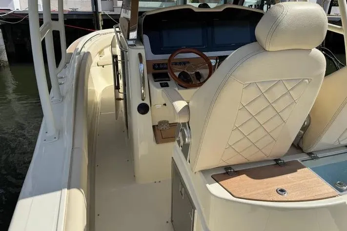Slide: The Image of 2018 Chris-Craft Catalina 30 boat interior with luxurious seating and modern dashboard. - 5