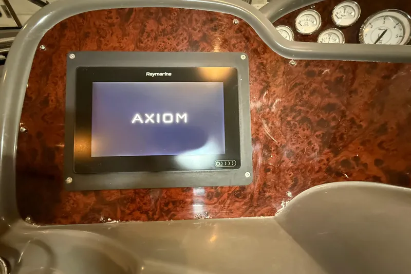 Slide: The Image of 2007 Regal Commodore 3760 IO dashboard with Raymarine Axiom display and gauges. - 10