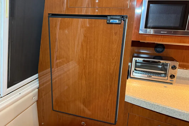 Slide: The Image of 2007 Regal Commodore 3760 IO yacht kitchen with wooden cabinetry and appliances. - 14