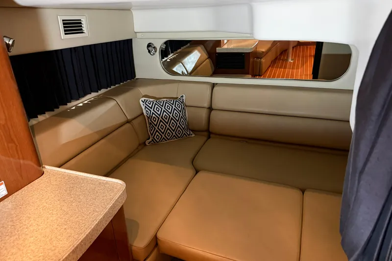 Slide: The Image of 2007 Regal Commodore 3760 IO interior with beige seating and decorative pillow. - 15