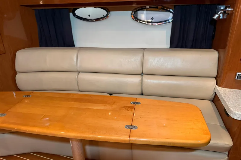 Slide: The Image of 2007 Regal Commodore 3760 IO interior with beige leather seating and wooden table. - 18