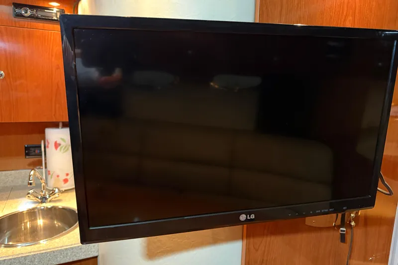 Slide: The Image of LG TV in 2007 Regal Commodore 3760 IO yacht interior, near sink and wooden cabinetry. - 19