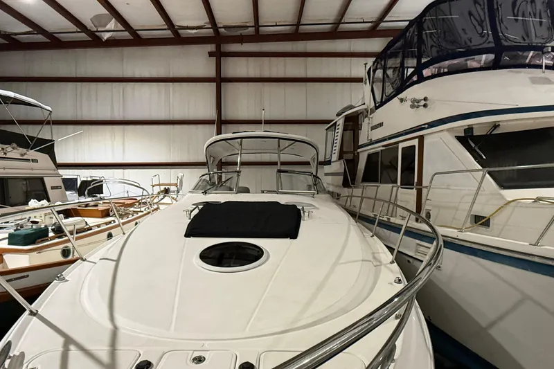 Slide: The Image of 2007 Regal Commodore 3760 IO yacht in indoor storage, surrounded by other boats. - 2