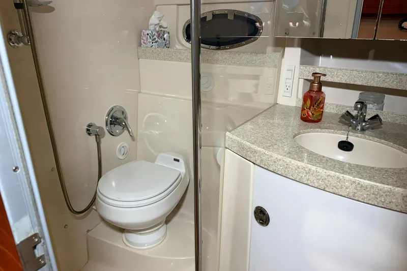 Slide: The Image of 2007 Regal Commodore 3760 IO yacht bathroom with toilet, sink, and shower. - 23