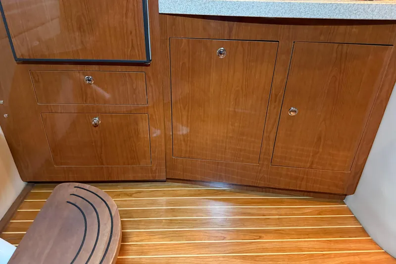 Slide: The Image of 2007 Regal Commodore 3760 IO interior with wooden cabinets and flooring. - 24