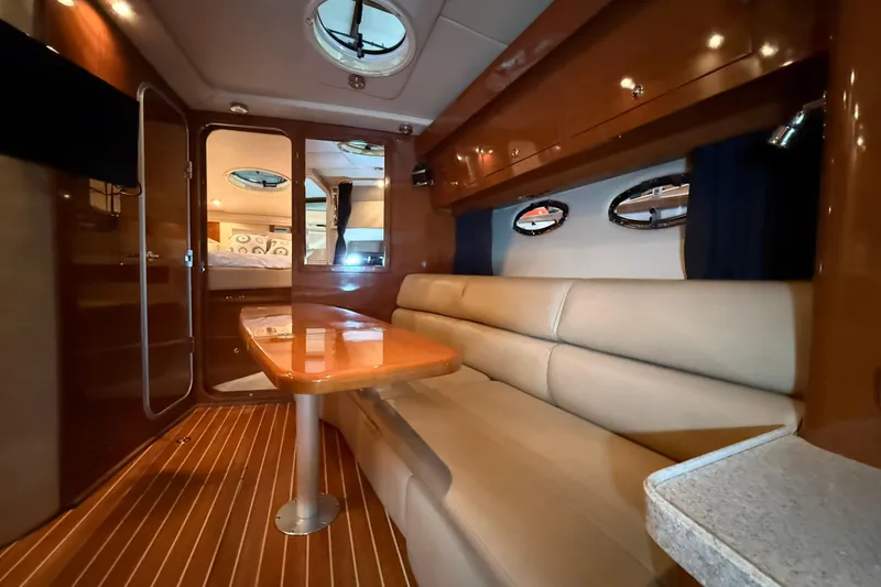 Slide: The Image of Luxurious interior of 2007 Regal Commodore 3760 IO yacht with plush seating and elegant wood finishes. - 26