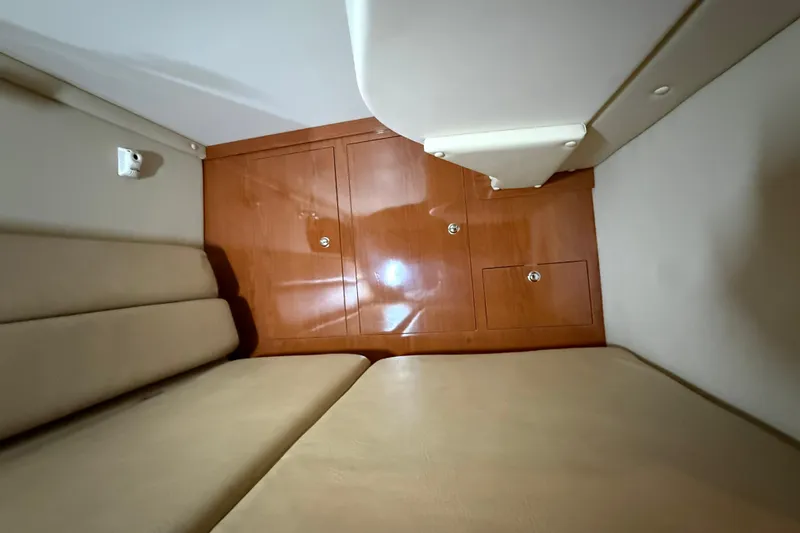 Slide: The Image of 2007 Regal Commodore 3760 IO cabin interior with beige seating and wooden cabinetry. - 27