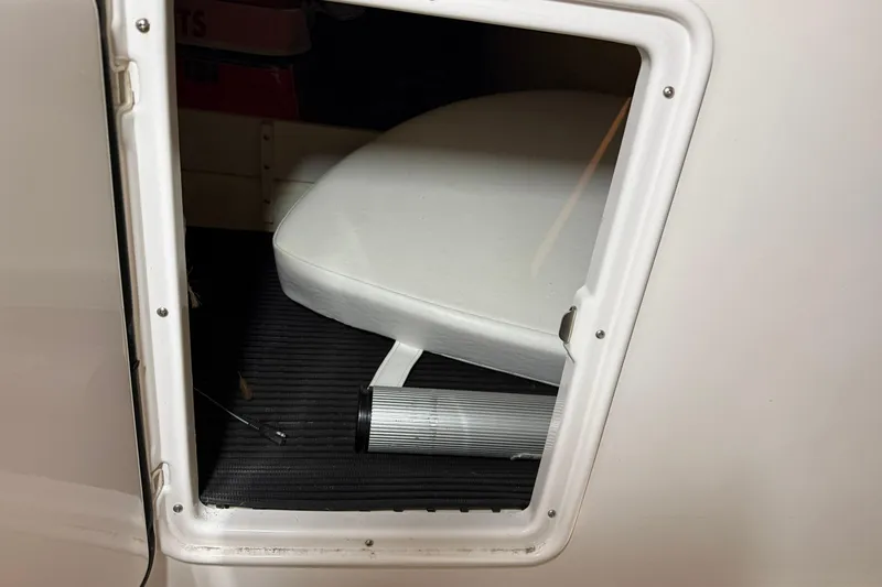Slide: The Image of 2007 Regal Commodore 3760 IO boat interior storage compartment with white cushion. - 32