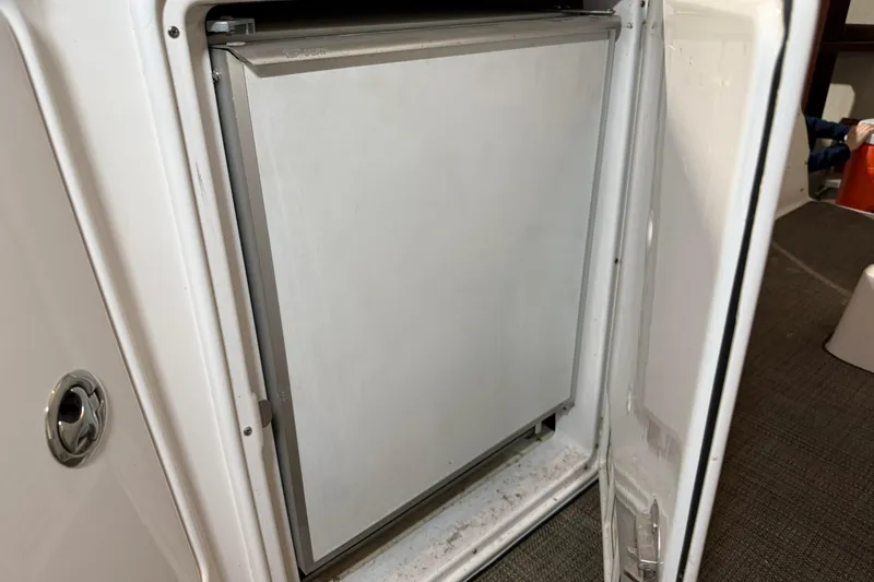 Slide: The Image of 2007 Regal Commodore 3760 IO boat refrigerator with open door, showcasing interior. - 33