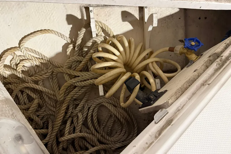 Slide: The Image of Storage compartment of 2007 Regal Commodore 3760 IO with coiled hose and ropes. - 37